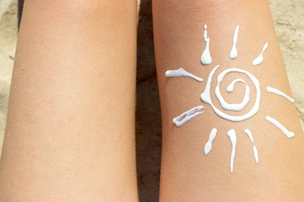 woman-sunbathing-on-the-beach-with-a-drawing-of-sun-on-her-leg-with-cream_t20_ax7Yxn.jpg